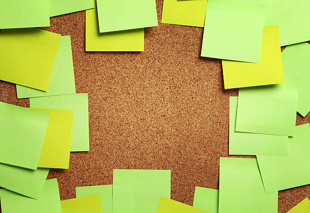 Image of blank sticky notes on cork bulletin board stock photo