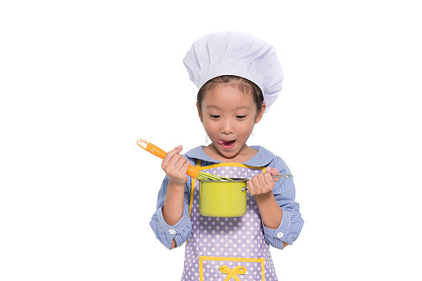 istock Little girl cooking 516456632