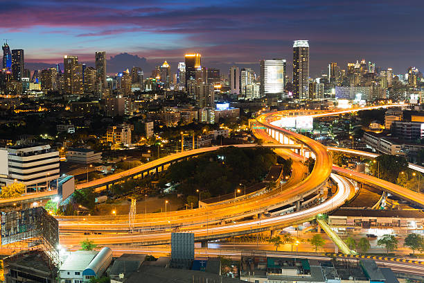 istock Aerial view expressway interchanged with city downtown background night view 516457018