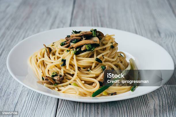 Spaghetti With Mushrooms And Onions On A White Plate Stock Photo - Download Image Now