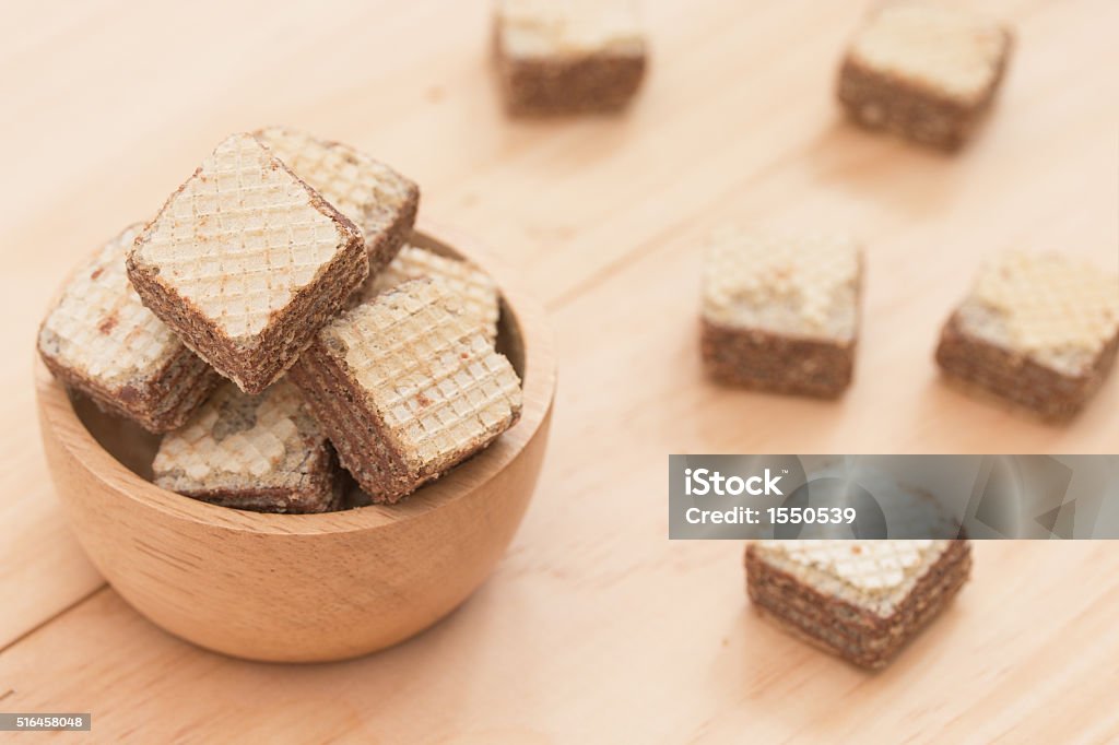 Wafers with chocolate in cup on wooden background. Backgrounds Stock Photo