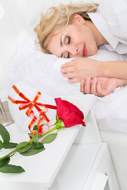 istock Beautiful young woman with a rose 516458086