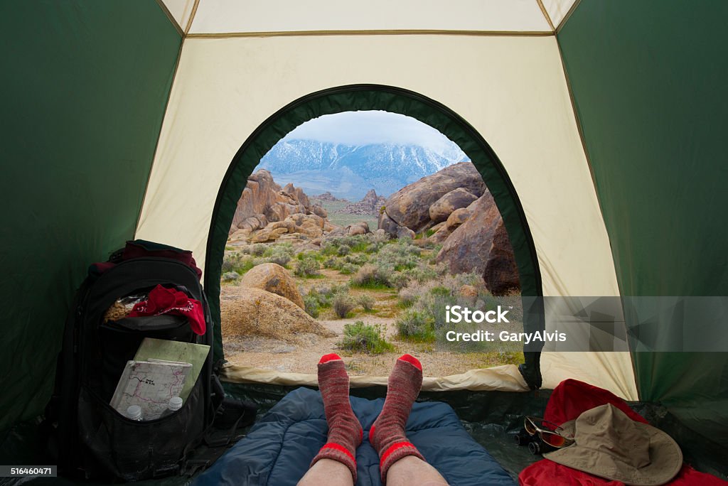 View of Alabama Hills, California-looking out of a backpacking tent. This is a view from inside a tent looking out to a view of the Alabama Hills, California with the snow capped Sierra Nevada Mountains in the distance. Alabama Hills Stock Photo