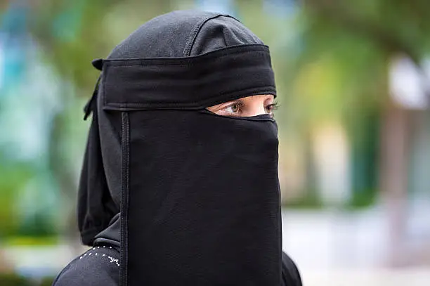 Close up picture of a beautiful  muslim woman wearing a niqab looking away
