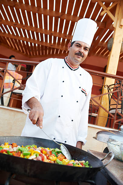 istock Arab chef frying meat on pan 516463135