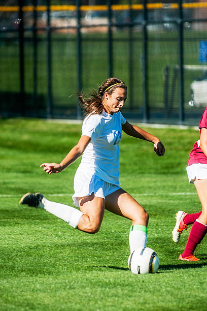 istock Attractive Female Soccer Player Starts Power Kick 516464347
