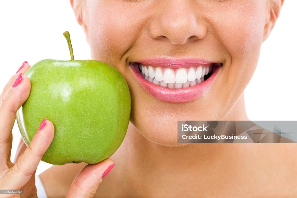 woman with an apple healthy teeth and green apple Apple - Fruit Stock Photo