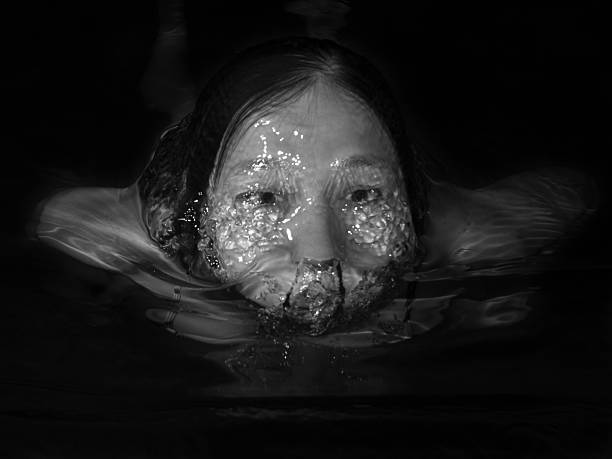 Monochrome image of a woman floating in water