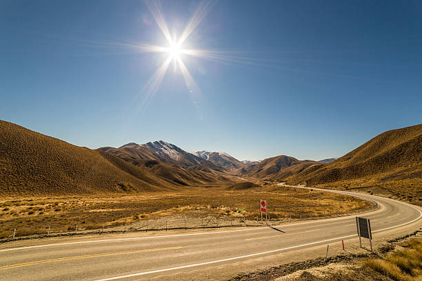 Country Road, Lindis Pass in Central South Island, through the mountains on a clear winter day.