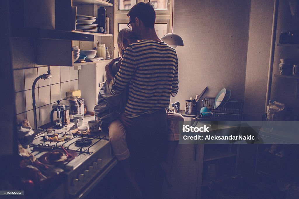 Romance in the kitchen Loving couple in the kitchen Dusk Stock Photo