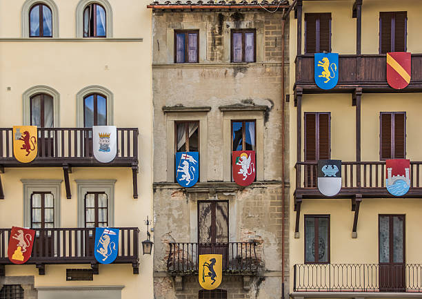 Building with medieval shields at the Piazza Grande in Arezzo, Italy
