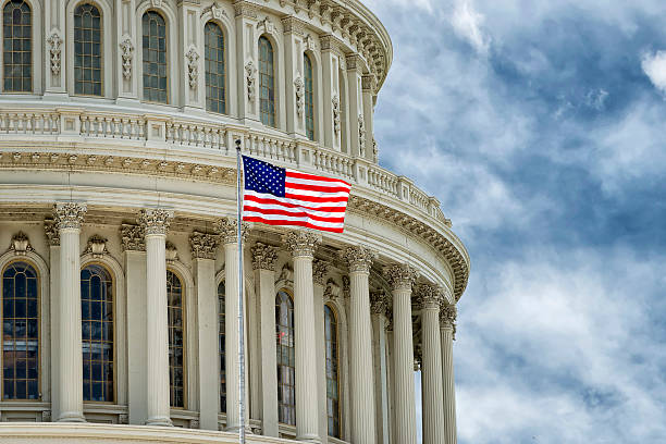 istock Washington DC Capitol dome detail on cloudy sky background 516484251