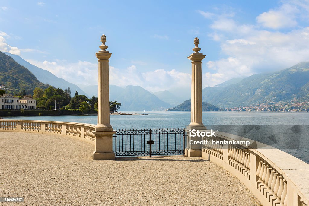 View of Lake Como seen from Gardens of Villa Melzi View of Lake Como flanked by roman columns at Villa Melzi near Bellagio, in the summer time. Gate Stock Photo