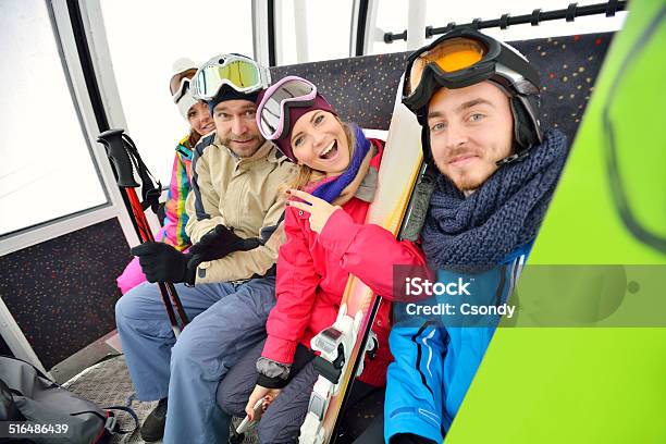 Young Snowboarding Team In The Ski Lift Stock Photo - Download Image Now - Friendship, Ski Lift, Teenager