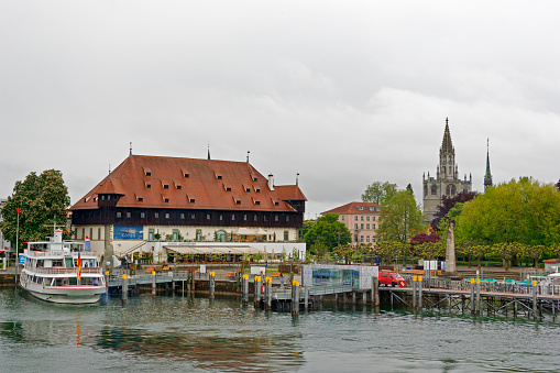 Constance, Germany - May 14, 2014: Konstanz is situated on Lake Constance. The Rhine river, which starts in the Swiss Alps, passes through Lake Constance and leaves it, considerably larger, by flowing under a bridge connecting the two parts of the city. With a population of more than 82,000 historical city of Constance is the largest town on Lake Constance and the perfect place for your vacation. The view of the city is characterized by its many old houses that stand on the shore of Lake Constance.
