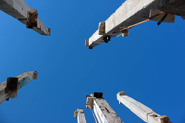 istock Concrete pillars at abandoned construction site on blue sky back 516492558