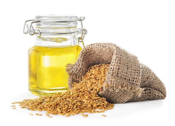 Linseed oil and golden flax seeds stock photo