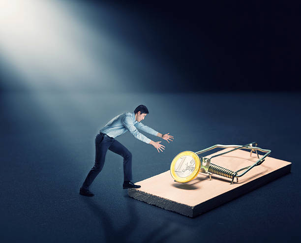 istock Man trying to pick a gold coin 516493182