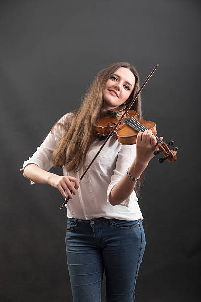 istock cheerful violinist with long hair 516493240