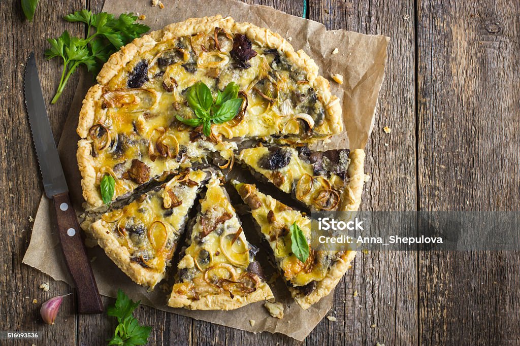 tart with mushrooms, leek and cheese tart with mushrooms, leek and cheese on rustic background Quiche Stock Photo