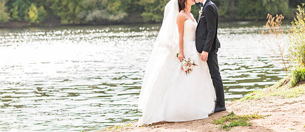 istock Wedding couple standing and hugging near lake 516493722