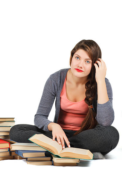 istock Girl with books isolated on white background. 516495920