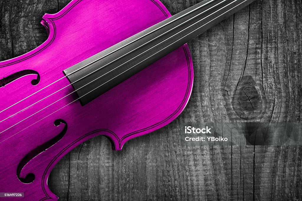 Pink Violin on grey wooden background. Pink Violin on grey wooden background. With space for text writing Alberta Stock Photo