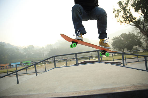 istock skateboarding legs at skatepark 516498414