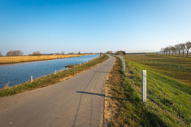 istock Meandering country road on a sunny winter day 516498568