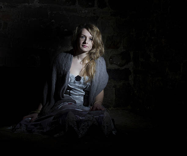 istock young female in dark room 516500328
