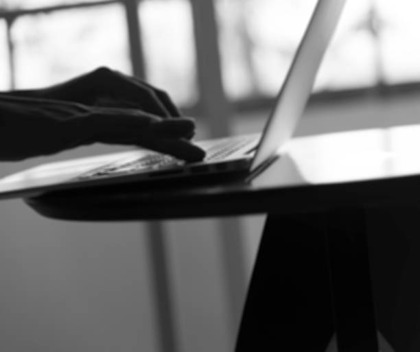 istock Silhouette blur  hand of man use slim notebook 516500372