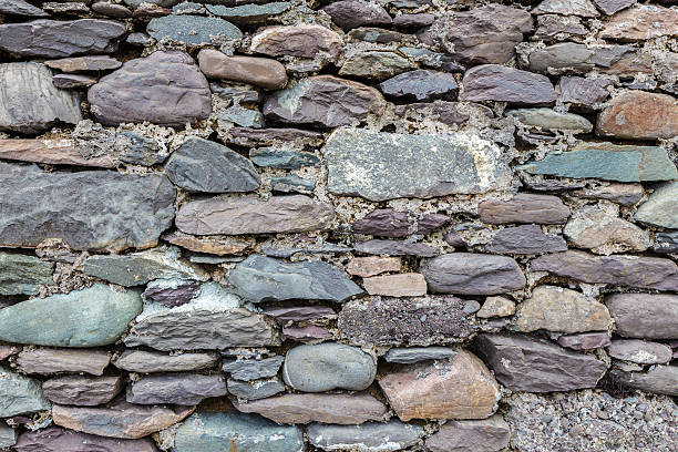 Ancient grey dry stone wall.  Can be used as background stock photo