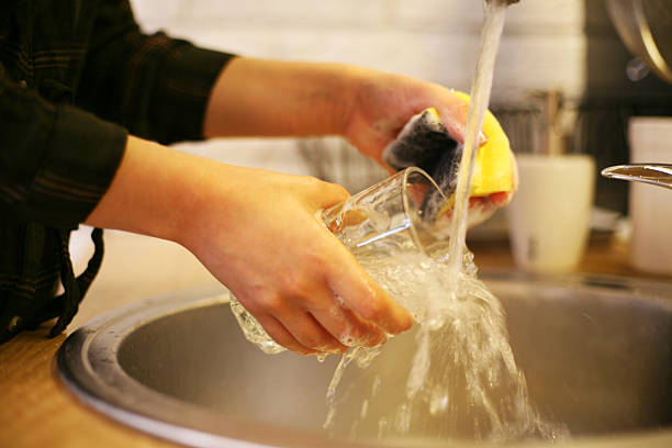 Woman washing dishes. Close up of woman hands washing dishes. wash dishes stock pictures, royalty-free photos & images