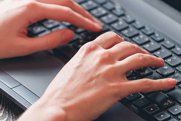 istock woman typing on laptop 516503734