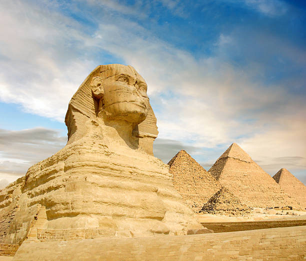 Famouse Sphinx and the great pyramids under interesting evening clouds, Cairo, Egypt