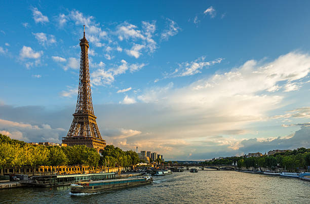 Beautiful sunset over Eiffel Tower and Seine river Beautiful sunset over Eiffel Tower and Seine river with puffy clouds, Paris, France champ de mars stock pictures, royalty-free photos & images