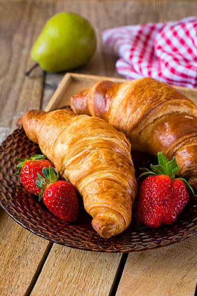 istock Croissants with fruits on plate 516505826