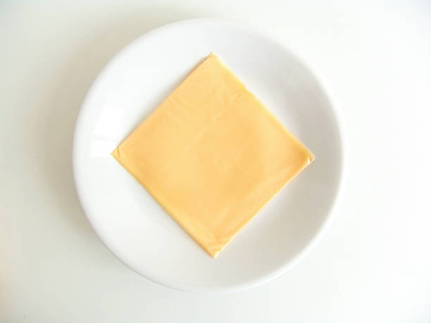 Cheese Slices Separately packed cheese slices. portion cut out cheese part of stock pictures, royalty-free photos & images