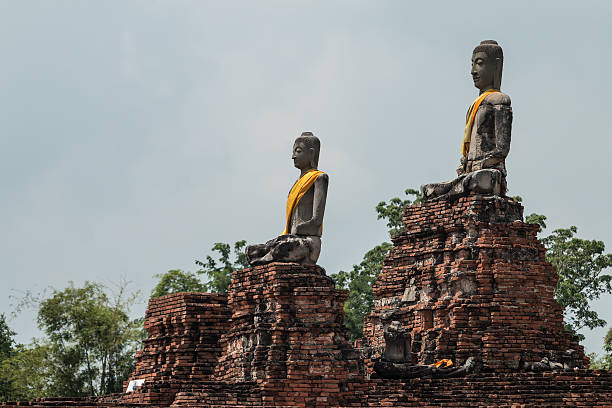 istock row of ruin buddha statue in wat chai wattanaram 516507421