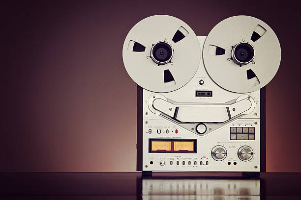 istock Analog Stereo Open Reel Tape Deck Recorder Vintage Closeup 516507497