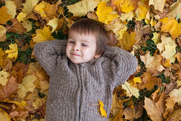 istock Cute little boy, lying on the ground 516507625