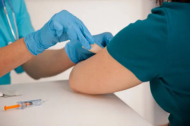 Photo of Medical: Nurse at pharmacy clinic giving flu shot to patient.