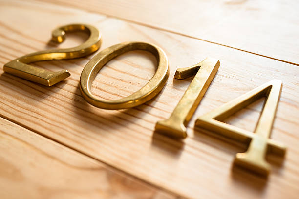 istock 2014 gold numbers text on plank wood 516508357