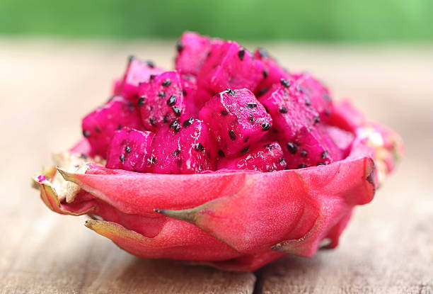 Pieces of dragon fruit Pieces of dragon fruit on wooden surface pitaya photos stock pictures, royalty-free photos & images