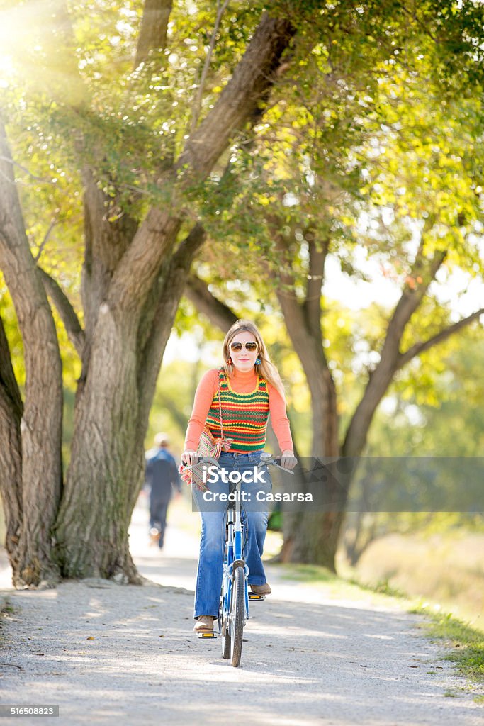 Vintage woman portrait Vintage woman portrait outdoors with her bicycle 1970 Stock Photo