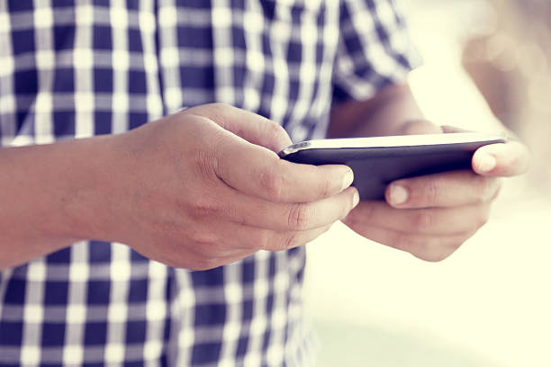 istock Close-up of a man holding a mobile phone 516509611