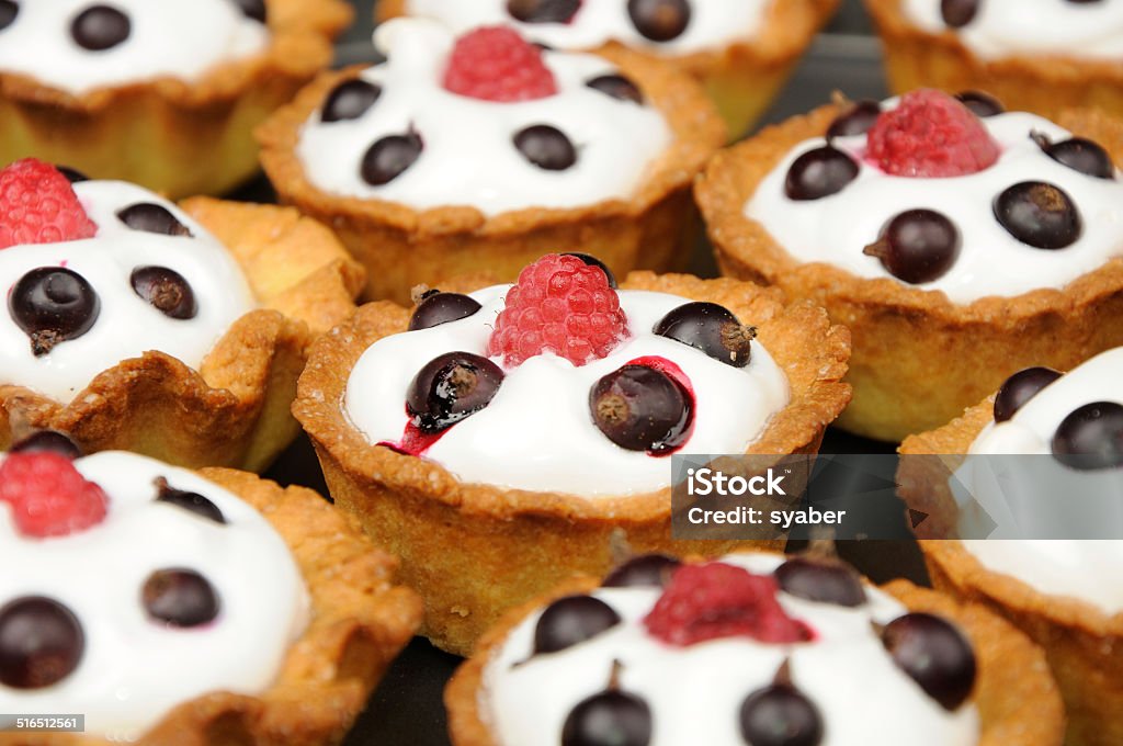 baked baskets with cream, black currant ant raspberry baked baskets with cream, black currant ant raspberry on the top. could bu used as background Baked Stock Photo