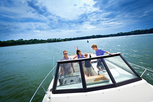 Subject: An American family boating on a lake with their pleasure boat.