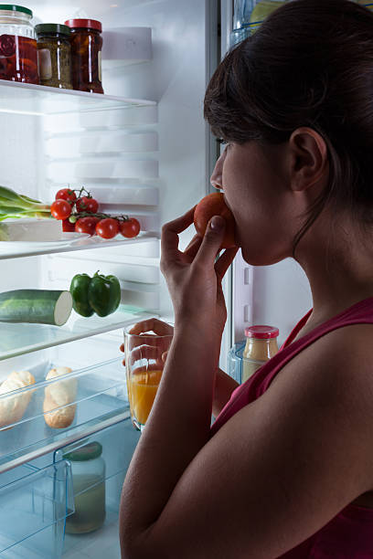 istock Girl eating peach 516527481