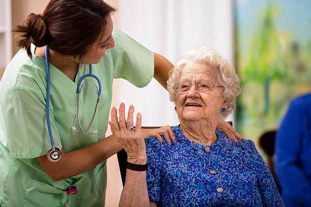 istock Caring Latin descent nurse talks with her elderly patient. 516527687